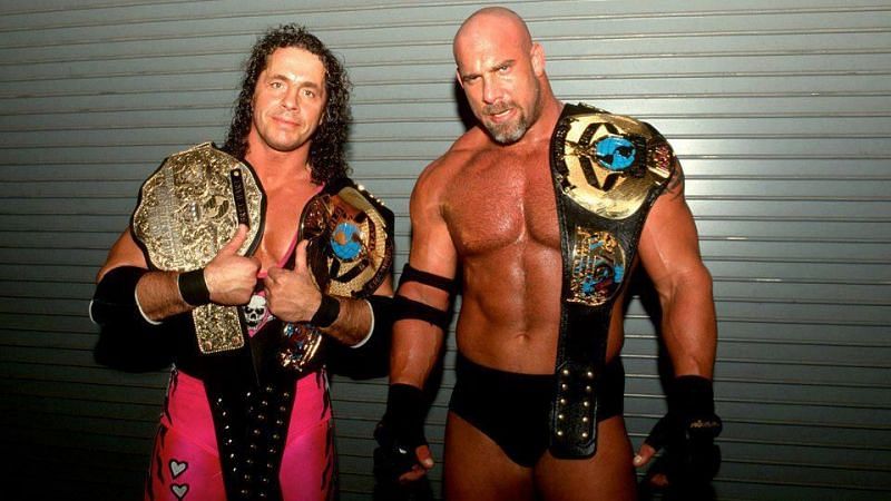 Bret Hart and Goldberg holding a lot of WCW's gold